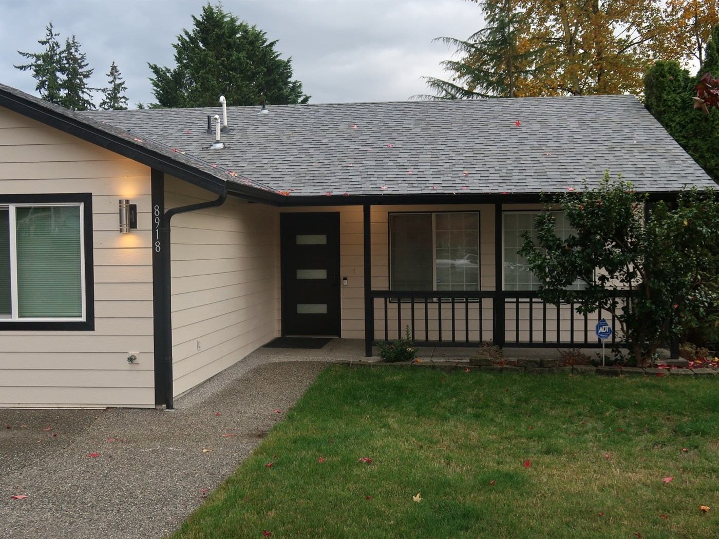 The front of Alder House of Comfort at 8918 1st St SE, with the walkway and covered entry